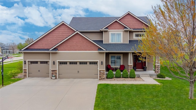 craftsman-style home with covered porch, concrete driveway, a front lawn, and stone siding