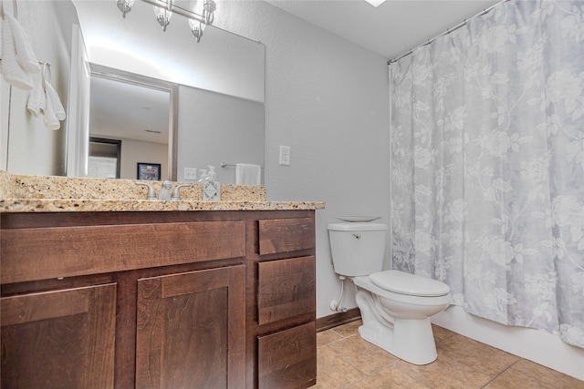 full bathroom featuring toilet, vanity, tile patterned floors, and baseboards