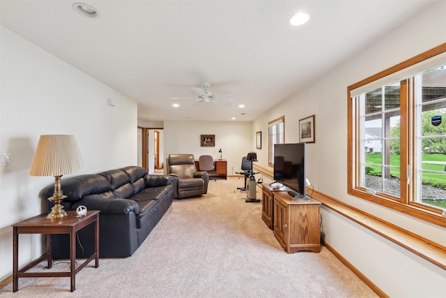 living room with ceiling fan, recessed lighting, baseboards, and light carpet