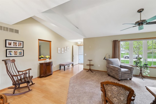 sitting room featuring visible vents, baseboards, light wood-type flooring, a ceiling fan, and lofted ceiling