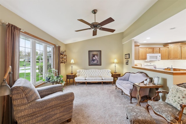 living room featuring lofted ceiling, a ceiling fan, and carpet flooring