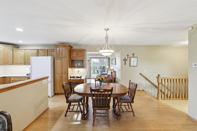 dining area with recessed lighting, light wood finished floors, and baseboards