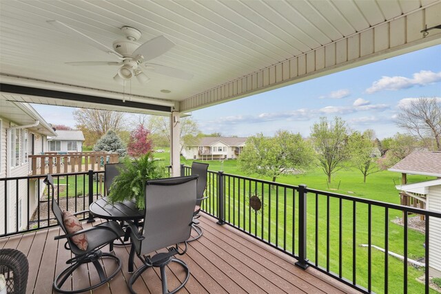 deck with ceiling fan and a lawn