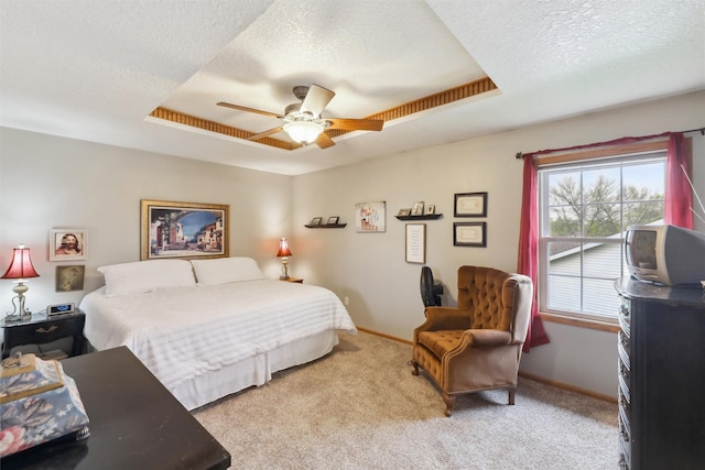bedroom with a textured ceiling, ceiling fan, baseboards, and light carpet