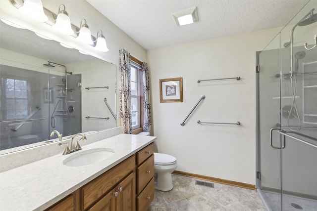 full bathroom featuring toilet, vanity, visible vents, a stall shower, and a textured ceiling