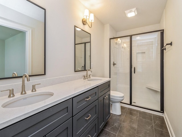 bathroom featuring toilet, a stall shower, and a sink