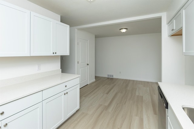 interior space featuring visible vents, a sink, and light wood finished floors