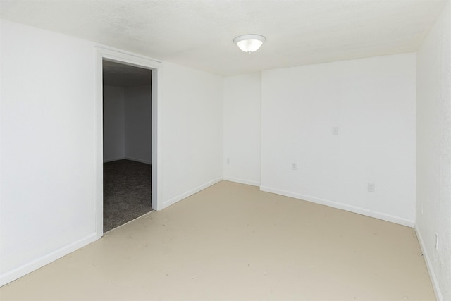 empty room featuring baseboards and finished concrete flooring