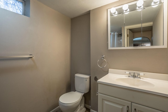 full bath featuring baseboards, toilet, a textured ceiling, and vanity