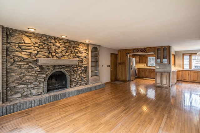 unfurnished living room with a fireplace and wood-type flooring