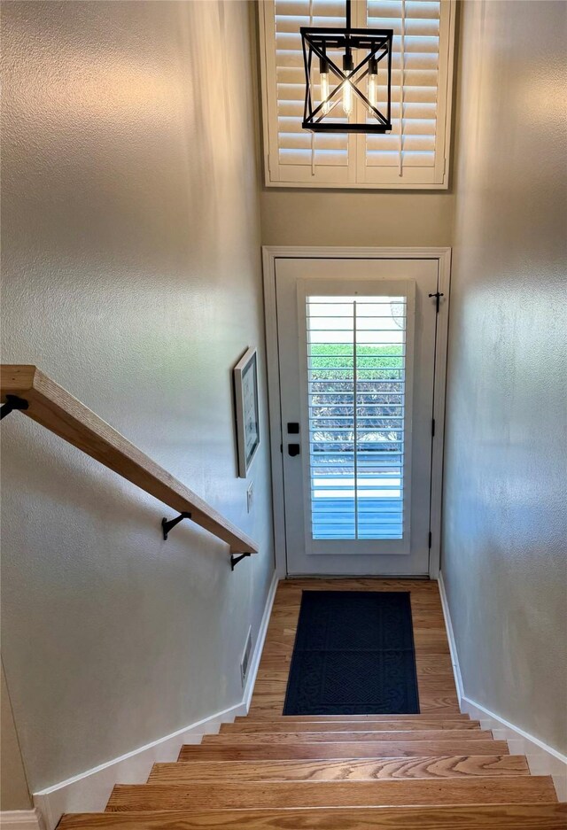 601 41st St, Des Moines, IA 50312 - entryway featuring wood finished floors, stairway, and a chandelier