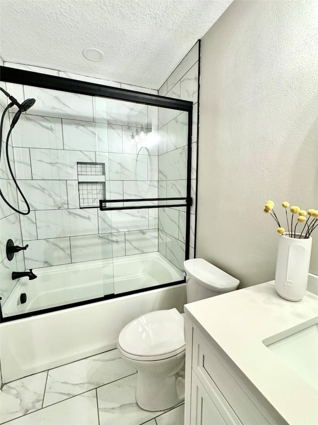 full bathroom featuring combined bath / shower with glass door, marble finish floor, toilet, vanity, and a textured ceiling