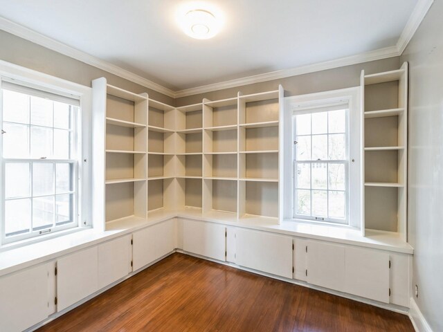 322 49th St, Des Moines, IA 50312 - empty room featuring dark wood-type flooring, crown molding, and healthy amount of natural light
