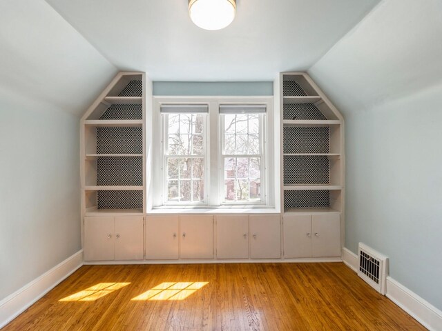 322 49th St, Des Moines, IA 50312 - additional living space featuring vaulted ceiling, light wood finished floors, and baseboards