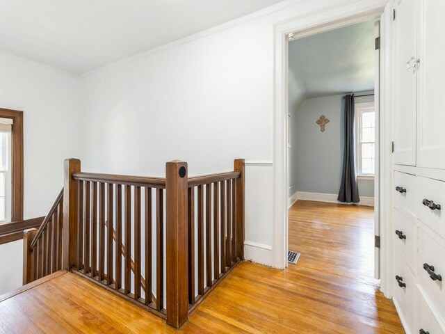 322 49th St, Des Moines, IA 50312 - hallway with an upstairs landing, light wood-type flooring, and baseboards