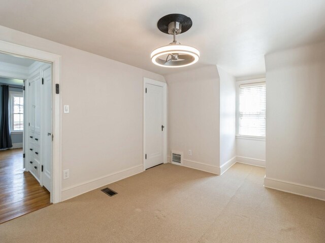 322 49th St, Des Moines, IA 50312 - empty room featuring light carpet and baseboards