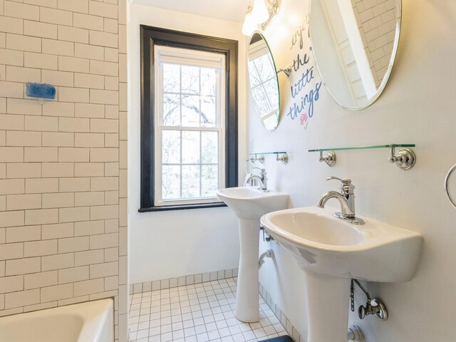 322 49th St, Des Moines, IA 50312 - bathroom featuring tile patterned flooring and bathing tub / shower combination