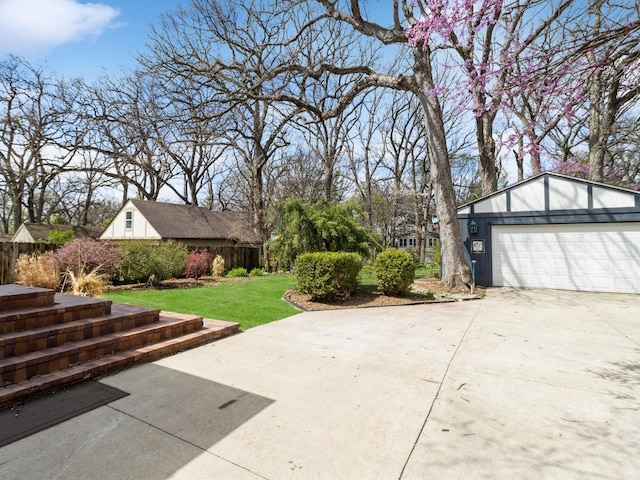 322 49th St, Des Moines, IA 50312 - view of patio / terrace featuring a garage and concrete driveway