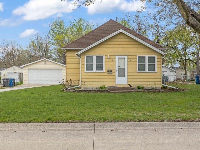 1313 Rose Ave, Des Moines, IA 50315 - bungalow-style home with an outbuilding, a front yard, and a detached garage