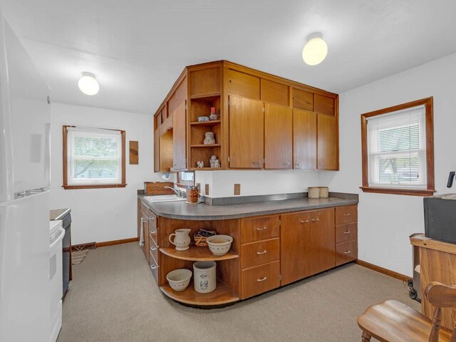 1313 Rose Ave, Des Moines, IA 50315 - kitchen featuring baseboards, open shelves, a sink, and brown cabinetry