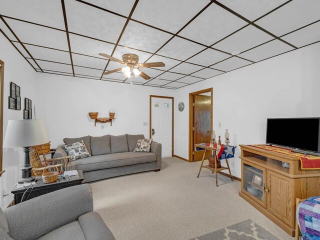 1313 Rose Ave, Des Moines, IA 50315 - living room featuring carpet floors, a ceiling fan, baseboards, and a paneled ceiling