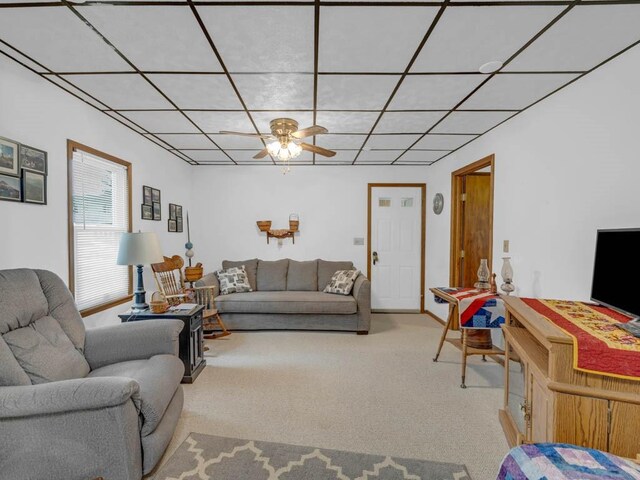1313 Rose Ave, Des Moines, IA 50315 - carpeted living room featuring a ceiling fan and a drop ceiling