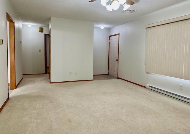 unfurnished room with visible vents, ceiling fan, carpet, and a baseboard radiator
