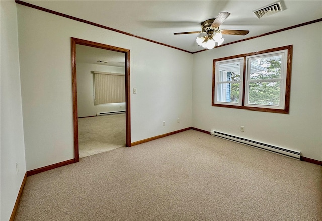 spare room featuring a baseboard heating unit, crown molding, visible vents, and light colored carpet
