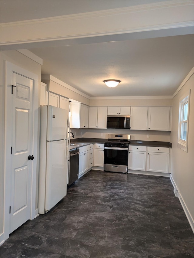 1300 NE 50th Pl, Des Moines, IA 50313 - kitchen with appliances with stainless steel finishes, dark countertops, white cabinets, and crown molding