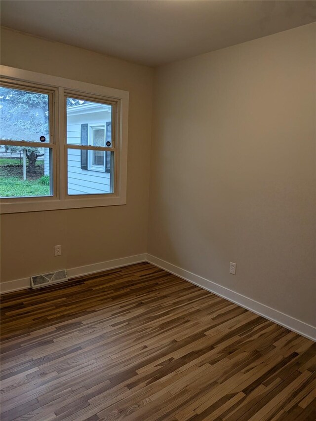 1300 NE 50th Pl, Des Moines, IA 50313 - unfurnished room featuring dark wood-style floors and baseboards