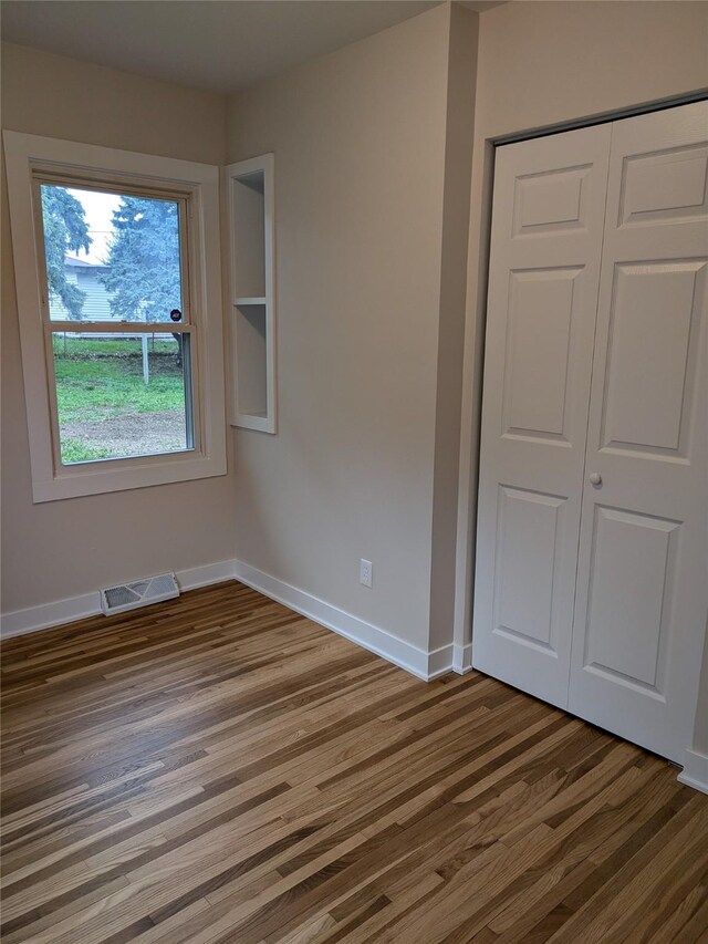 1300 NE 50th Pl, Des Moines, IA 50313 - unfurnished bedroom with wood finished floors and a closet