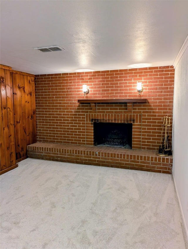1300 NE 50th Pl, Des Moines, IA 50313 - unfurnished living room with a brick fireplace, carpet flooring, and wood walls
