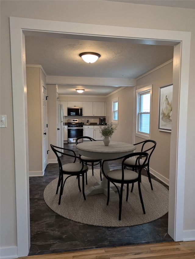 1300 NE 50th Pl, Des Moines, IA 50313 - dining area with dark wood-style flooring and crown molding