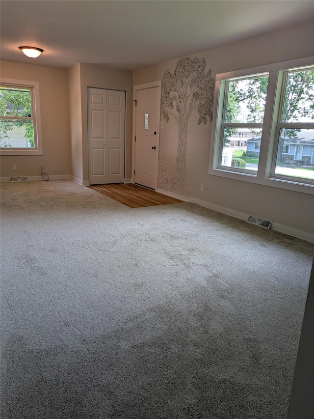 1300 NE 50th Pl, Des Moines, IA 50313 - unfurnished living room featuring carpet flooring