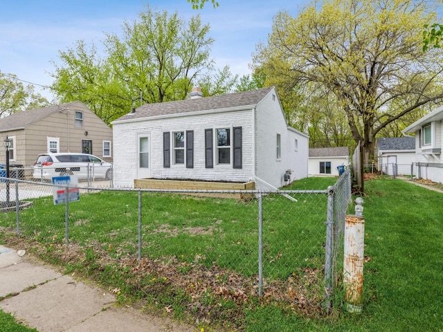 bungalow-style home with fence, a shingled roof, and a front lawn