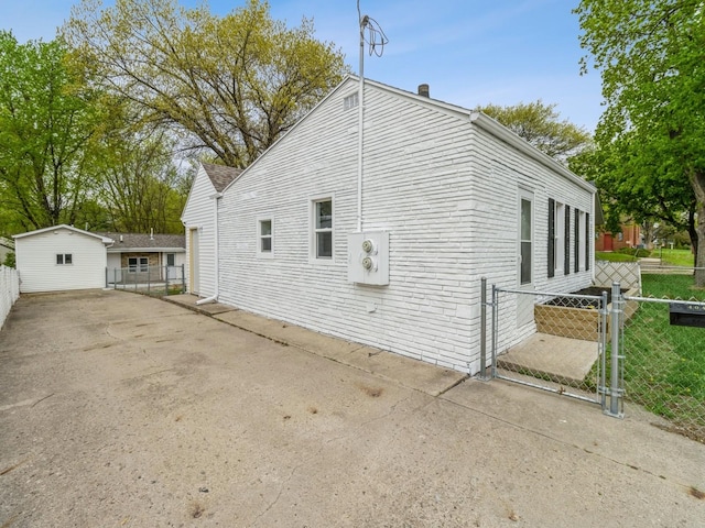 view of property exterior with fence and a gate