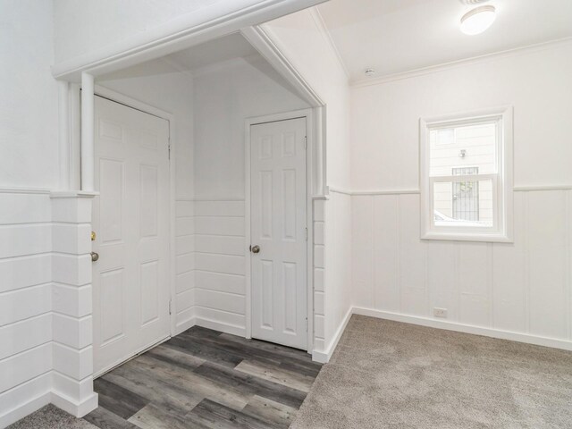4040 6th Ave, Des Moines, IA 50313 - empty room featuring wainscoting, ornamental molding, and dark wood-style floors