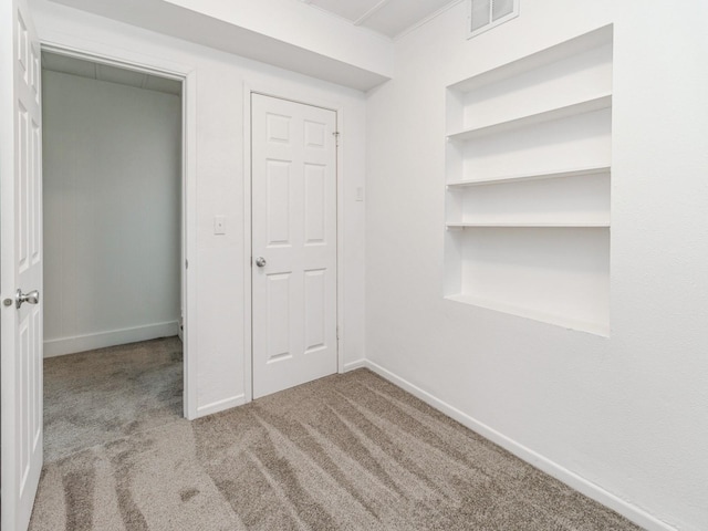 unfurnished bedroom with baseboards, carpet flooring, and visible vents