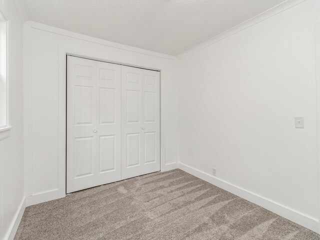 4040 6th Ave, Des Moines, IA 50313 - unfurnished bedroom featuring carpet, a closet, and baseboards