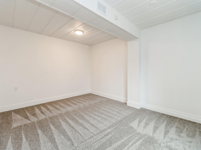 finished below grade area featuring carpet floors, baseboards, and visible vents