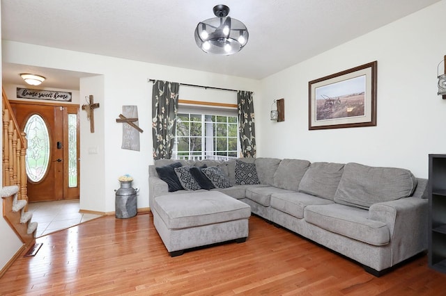 living area with baseboards and wood finished floors