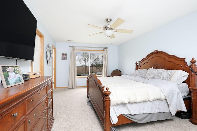 bedroom with ceiling fan, light carpet, and baseboards