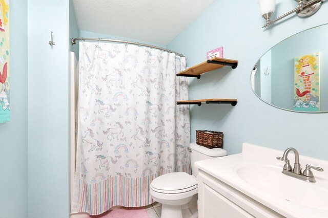 full bathroom featuring vanity, tile patterned flooring, toilet, and curtained shower