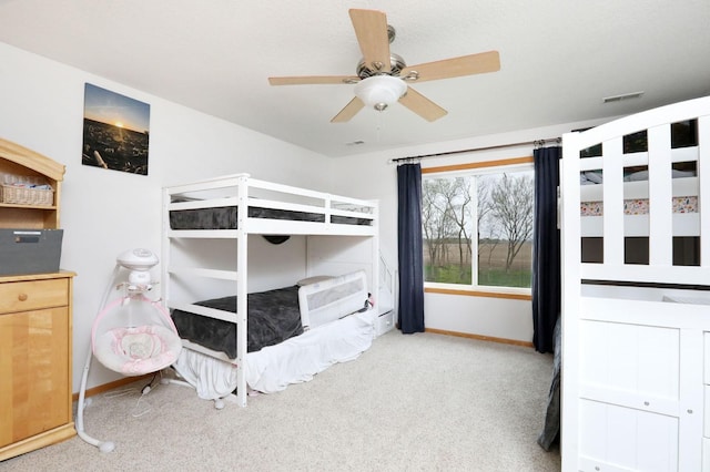 bedroom featuring baseboards, visible vents, ceiling fan, and carpet