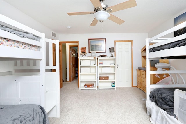 carpeted bedroom featuring ceiling fan and visible vents