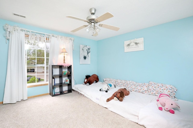 bedroom featuring visible vents, carpet flooring, baseboards, and a ceiling fan