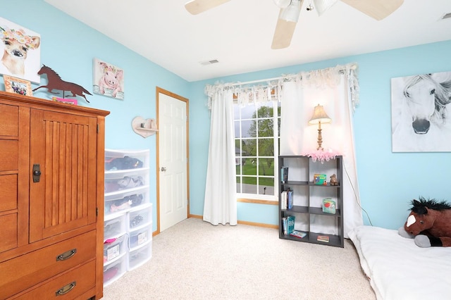 carpeted bedroom featuring baseboards, ceiling fan, and visible vents