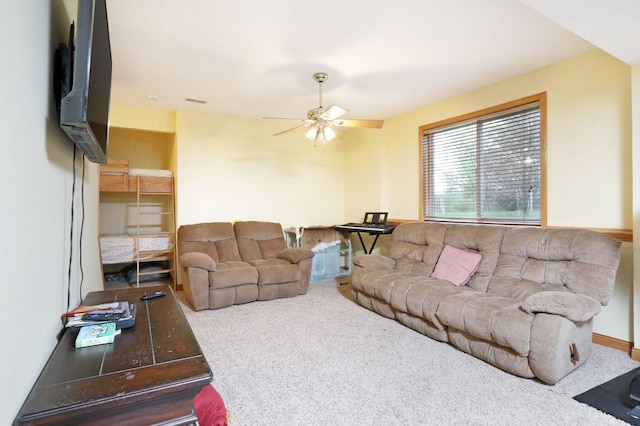 living room with ceiling fan and carpet