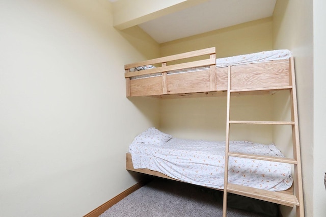 bedroom with baseboards and carpet flooring