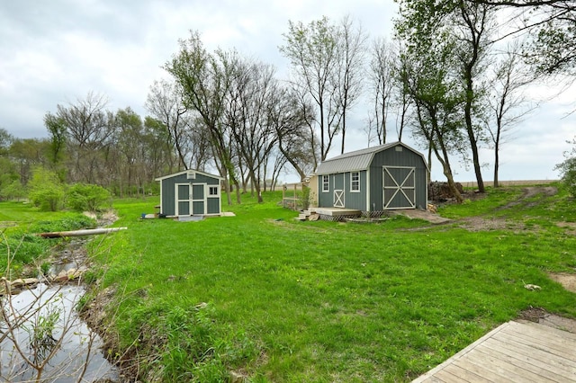 view of yard featuring a storage shed and an outbuilding